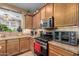 Stylish kitchen with wood cabinets, gas range and built in oven at 36248 W Cartegna Ln, Maricopa, AZ 85138