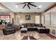 Relaxing living room featuring a sectional sofa and large windows at 36248 W Cartegna Ln, Maricopa, AZ 85138