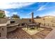 Outdoor patio with seating area, grill, and umbrella at 36248 W Cartegna Ln, Maricopa, AZ 85138