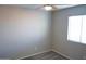 Simple bedroom with ceiling fan and window blinds at 36285 N Mirandesa Dr, San Tan Valley, AZ 85143