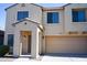 Two-story house with tan exterior, two-car garage, and landscaping at 36285 N Mirandesa Dr, San Tan Valley, AZ 85143