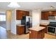 Kitchen with dark wood cabinets, stainless steel appliances, and island at 36285 N Mirandesa Dr, San Tan Valley, AZ 85143