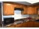 View of kitchen with oak cabinets and granite counters at 431 W Knox Rd, Chandler, AZ 85225