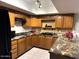 Kitchen features granite countertops and oak cabinets at 431 W Knox Rd, Chandler, AZ 85225