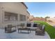 Spacious backyard with a grassy area and patio furniture, perfect for relaxation at 43102 W Venture Rd, Maricopa, AZ 85138