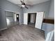 Bedroom with mirrored closet doors and wood flooring at 43102 W Venture Rd, Maricopa, AZ 85138