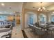 Elegant dining room with a large table, chandelier, and views into the kitchen at 43102 W Venture Rd, Maricopa, AZ 85138