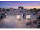 Single-story home with a neutral color palette and a two-car garage at 43102 W Venture Rd, Maricopa, AZ 85138