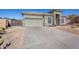 House with two-car garage and desert landscaping at 43102 W Venture Rd, Maricopa, AZ 85138