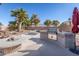 Relaxing pool area with fire pit and outdoor kitchen at 43102 W Venture Rd, Maricopa, AZ 85138