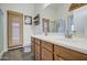 Double vanity bathroom with wood cabinets and a shower with a bamboo door at 4710 E Torrey Pines Ln, Chandler, AZ 85249