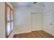 Simple bedroom with wood floors, plantation shutters and double door closet at 4710 E Torrey Pines Ln, Chandler, AZ 85249