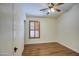 Bright bedroom featuring wood floors, plantation shutters and a ceiling fan at 4710 E Torrey Pines Ln, Chandler, AZ 85249