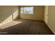 Bright bedroom with window, neutral walls and carpet at 4730 W Rose Ln, Glendale, AZ 85301