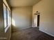 Sunlit bedroom with large window and neutral carpet at 4730 W Rose Ln, Glendale, AZ 85301