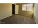 Well-lit bedroom with window, closet, and neutral decor at 4730 W Rose Ln, Glendale, AZ 85301