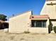 Tan stucco exterior with a reddish tile roof and a window with security bars at 4730 W Rose Ln, Glendale, AZ 85301