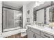 Modern bathroom with gray tile, a shower/tub combo, and a vanity at 5100 E Rancho Paloma Pkwy # 1014, Cave Creek, AZ 85331