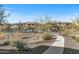 Community pool with a walkway and surrounding desert landscape at 5100 E Rancho Paloma Pkwy # 1014, Cave Creek, AZ 85331