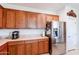 Kitchen with stainless steel appliances and wood cabinets at 5352 N Gila Trail Dr, Eloy, AZ 85131