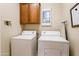 Bright laundry room, washer, dryer, cabinets, and storage at 5352 N Gila Trail Dr, Eloy, AZ 85131