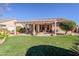 Covered patio with seating area, artificial turf, and pergola at 5352 N Gila Trail Dr, Eloy, AZ 85131