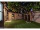 Night view of a well-maintained storage shed in a backyard with artificial turf at 5402 E Paradise Ln, Scottsdale, AZ 85254