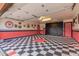 Garage with retro-themed floor and storage cabinets at 5402 E Paradise Ln, Scottsdale, AZ 85254