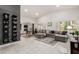 Spacious living room with a sectional sofa, marble floors, and built-in shelving at 5402 E Paradise Ln, Scottsdale, AZ 85254