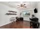 Home office features wood flooring and built-in shelving at 5402 E Paradise Ln, Scottsdale, AZ 85254