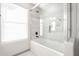 Clean bathroom with a shower/tub combo and large window at 5432 E Grandview Rd, Scottsdale, AZ 85254