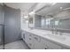 Elegant bathroom with double vanity, large mirror, and barn door at 5432 E Grandview Rd, Scottsdale, AZ 85254