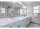 Bathroom with double vanity, large mirror, and walk-in shower at 5432 E Grandview Rd, Scottsdale, AZ 85254