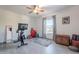 Bright bedroom with Peloton bike, ceiling fan, and large window at 5432 E Grandview Rd, Scottsdale, AZ 85254