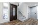 Entryway with dark wood door and staircase leading upstairs at 5432 E Grandview Rd, Scottsdale, AZ 85254