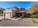 Two-story house with stone accents and a landscaped front yard at 5432 E Grandview Rd, Scottsdale, AZ 85254