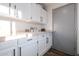 Laundry room with built-in cabinets and countertop at 5432 E Grandview Rd, Scottsdale, AZ 85254