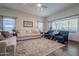 Bright living room with hardwood floors, neutral colored couches and blue accent chairs at 5432 E Grandview Rd, Scottsdale, AZ 85254