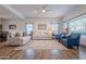 Bright living room with hardwood floors, neutral colored couches and blue accent chairs at 5432 E Grandview Rd, Scottsdale, AZ 85254