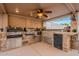 Outdoor kitchen with built-in grill, sink, and mini-fridge at 5432 E Grandview Rd, Scottsdale, AZ 85254