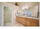 Double sink bathroom with wood cabinets and an additional room at 5819 S 102Nd Dr, Tolleson, AZ 85353