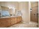 Bathroom boasts dual sinks, wood cabinets, and a walk-in shower at 5819 S 102Nd Dr, Tolleson, AZ 85353