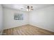 Light and airy bedroom with wood flooring and a large window at 5819 S 102Nd Dr, Tolleson, AZ 85353