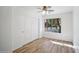 Well-lit bedroom with wood flooring and a double door closet at 5819 S 102Nd Dr, Tolleson, AZ 85353