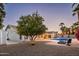 Landscaped backyard with a pool, patio, and citrus tree at 6102 E Nisbet Rd, Scottsdale, AZ 85254