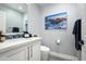 Small bathroom with single sink, toilet and a decorative painting at 6102 E Nisbet Rd, Scottsdale, AZ 85254