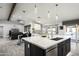 Open concept kitchen with island, stainless steel appliances, and white cabinets at 6102 E Nisbet Rd, Scottsdale, AZ 85254