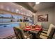 Outdoor patio dining area with string lights and pool view at 6102 E Nisbet Rd, Scottsdale, AZ 85254