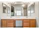 Double vanity bathroom with large mirror and bright lighting at 6751 N 77Th Dr, Glendale, AZ 85303