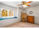 Bedroom with window seat, stained glass, and dresser at 6751 N 77Th Dr, Glendale, AZ 85303